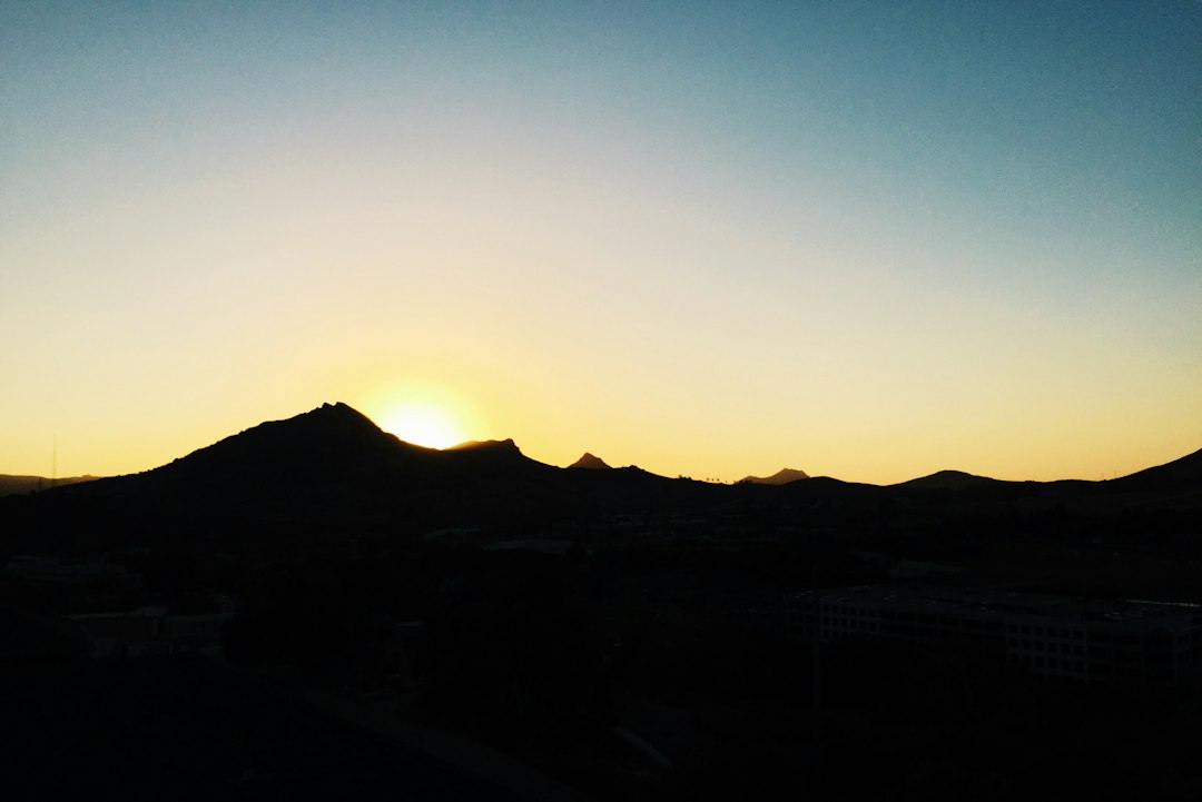Bishop Peak silhouetted at golden hour above San Luis Obispo